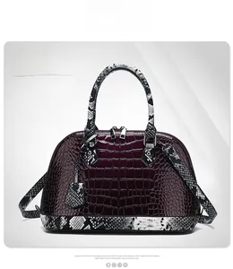 Detailed view of purple croc-embossed handbag with python print leather accents