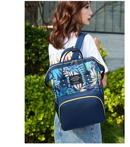 Detail of blue floral maternity backpack with tropical leaf print and spacious design