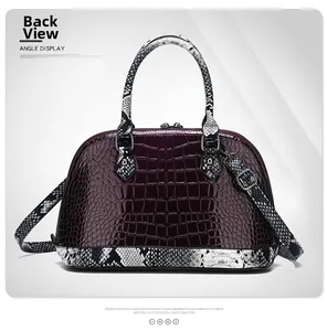 Detail view of burgundy crocodile skin pattern and snake print accents on the shell bag back