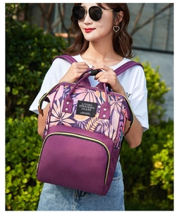 Outdoor shot of purple floral backpack showing durable material and stylish leaf pattern