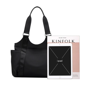 Large black Oxford nylon tote bag for women showing spacious interior with iPad and magazine