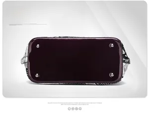 Detail view of the crocodile pattern handbag base with four silver metal protective studs