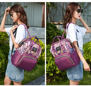 Outdoor shot of a purple floral backpack with large capacity and multi-pocket structure