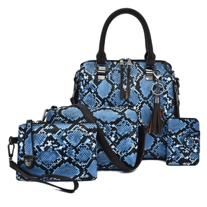 Blue crocodile pattern four-piece handbag set featuring tote, crossbody and purse combo