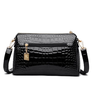 Glossy black patent leather crossbody bag with crocodile pattern and gold hardware