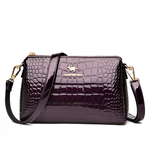 Deep purple patent leather crossbody bag with crocodile texture and gold hardware