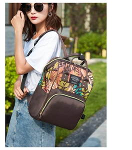 Detail of fashion backpack with tropical leaf print and brown拼接 outdoor park view