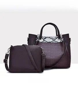 Detail of dark brown faux leather tote and crossbody bag set with crocodile texture