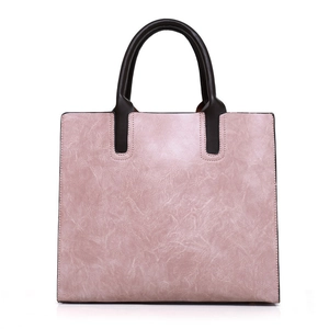 Vintage tote bag in dusty rose faux leather with contrasting dark brown handles and a structured design