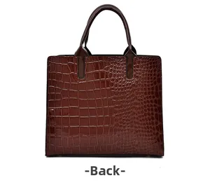 Back view of brown crocodile texture tote bag with glossy faux leather and sturdy handles