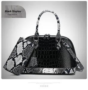 Detail of black crocodile embossed shell bag paired with a matching snake pattern wallet