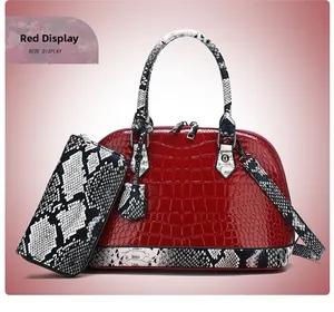 Detail of red crocodile embossed handbag set with snake print handles and matching wallet