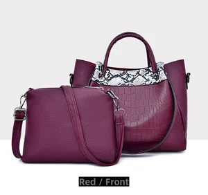 Front view of burgundy red faux leather tote and crossbody bag set with crocodile pattern