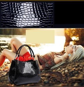 Macro view of black crocodile pattern leather and woven handle detail on fashion handbag