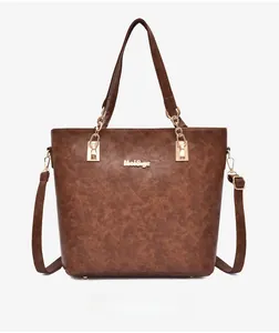 Front view of large brown tote bag with marble texture, gold hardware and chain detail