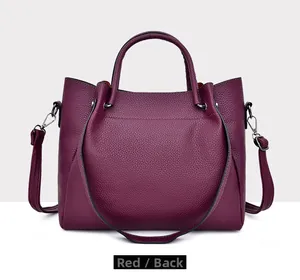 Detailed back view of a burgundy pebble grain leather bucket bag with silver hardware