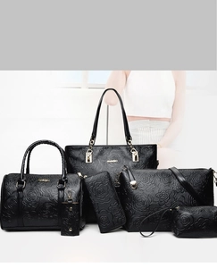 Detail of 6-piece black leather handbag set with rose embossing and gold hardware