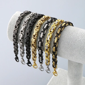 Detail of Byzantine link bracelets in steel, gold, and black colors with lobster clasps