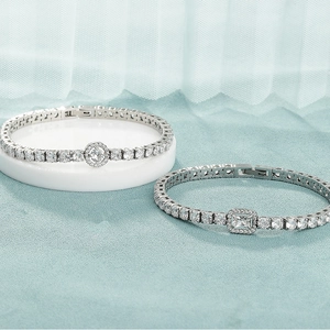 Detail of silver tennis bracelets with round and rectangular cubic zirconia settings