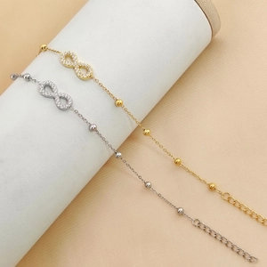 Detailed view of infinity symbol bracelets with gold and silver finishes and pavé zircons