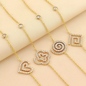 Set of four gold stainless steel bracelets with heart and clover zircon pendants
