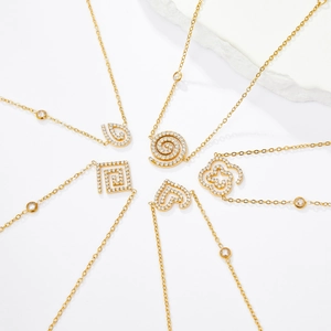 Detailed view of 18K gold-plated heart and geometric pendants with sparkling crystals