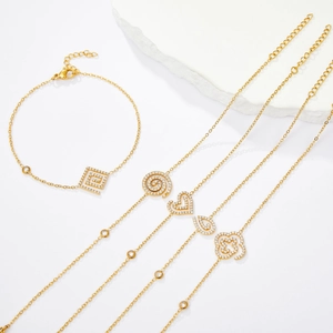 Minimalist gold heart bracelet and necklaces set with sparkling zircon stones