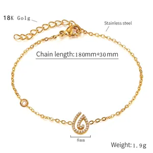Macro detail of gold stainless steel bracelet with rhinestone drop pendant and dimensions