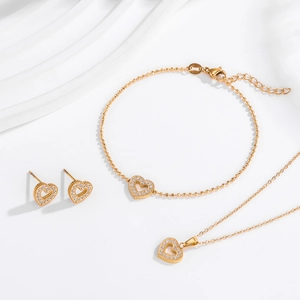 Elegant gold heart jewelry set with micro-paved zircons featuring necklace and bracelet