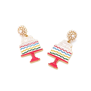 Detail of colorful rainbow cake earrings with pearls and Happy Birthday engraving