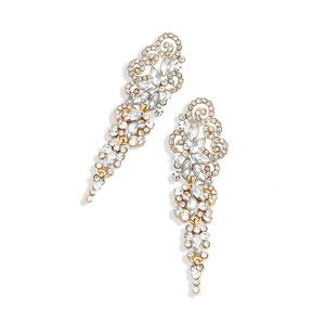 Close-up of vintage gold tassel earrings with glittering crystals in baroque style