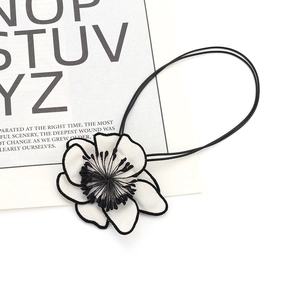 Elegant black and white fabric camellia hair tie with embroidered petals and elastic band