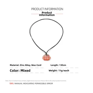 Detail showing the checkered orange pumpkin pendant with 130cm black wax rope cord