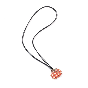 Minimalist enamel pumpkin pendant necklace with orange checkered pattern on black cord