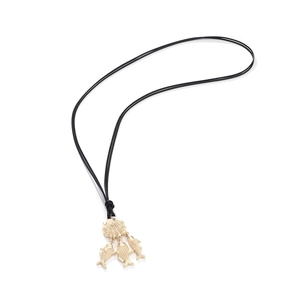 Adjustable seashell and tropical fish pendant necklace with a black cord on a white base
