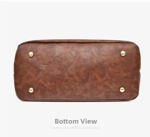 Detailed view of brown lychee grain leather handbag base with four gold protective studs