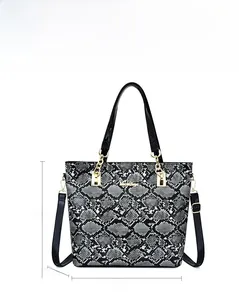 Detailed view of snake skin pattern tote bag with golden hardware and dimensions 29x13x28cm