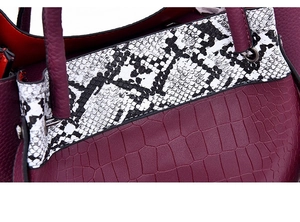 Detailed macro view of crocodile pattern faux leather with snakeskin print accents