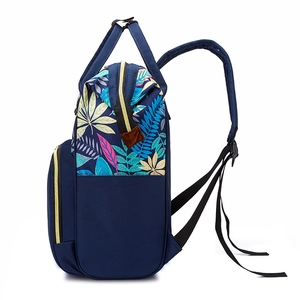 Stylish navy blue waterproof diaper backpack with colorful tropical leaf print and gold zippers