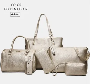 Detail of golden 6-piece handbag set featuring embossed rose patterns and PU leather