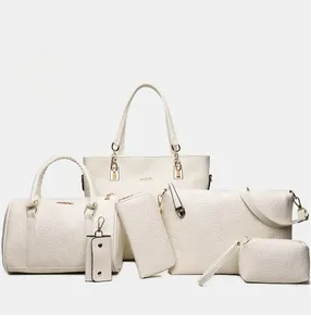 Detail of white 6-piece handbag set featuring embossed rose floral patterns on PU leather