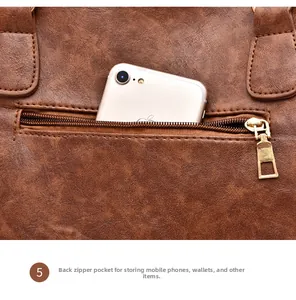 Detail of the back zipper pocket on the brown leather tote bag for phone storage