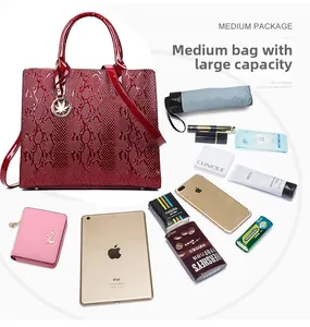 Detail view of red snakeskin handbag showing large capacity for iPad and daily essentials