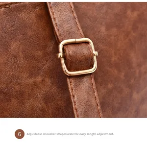 Close-up of adjustable golden buckle on brown lychee texture faux leather strap