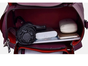 Spacious interior of burgundy faux leather bucket bag showing storage for tablet and umbrella