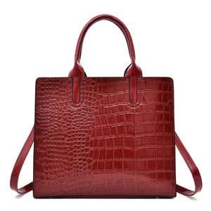Deep red crocodile embossed patent leather tote bag with sturdy handles and shoulder strap