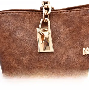 Detail of brown litchi pattern leather bag with golden chain and metallic letter M