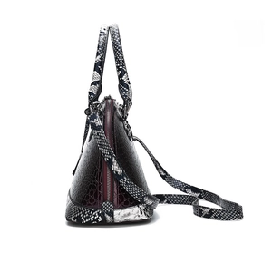 Deep burgundy crocodile-embossed satchel bag with black and white snake-print straps