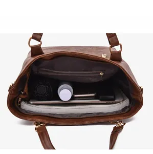 Top view showing the spacious interior and logo print lining of the brown tote bag