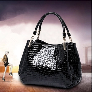 Classic black crocodile pattern tote bag with woven handles and golden hardware